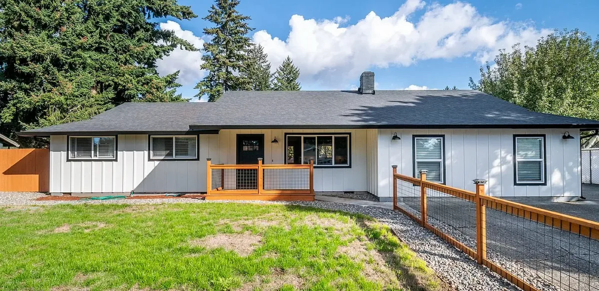 The ranch home after, with a new dark gray roof