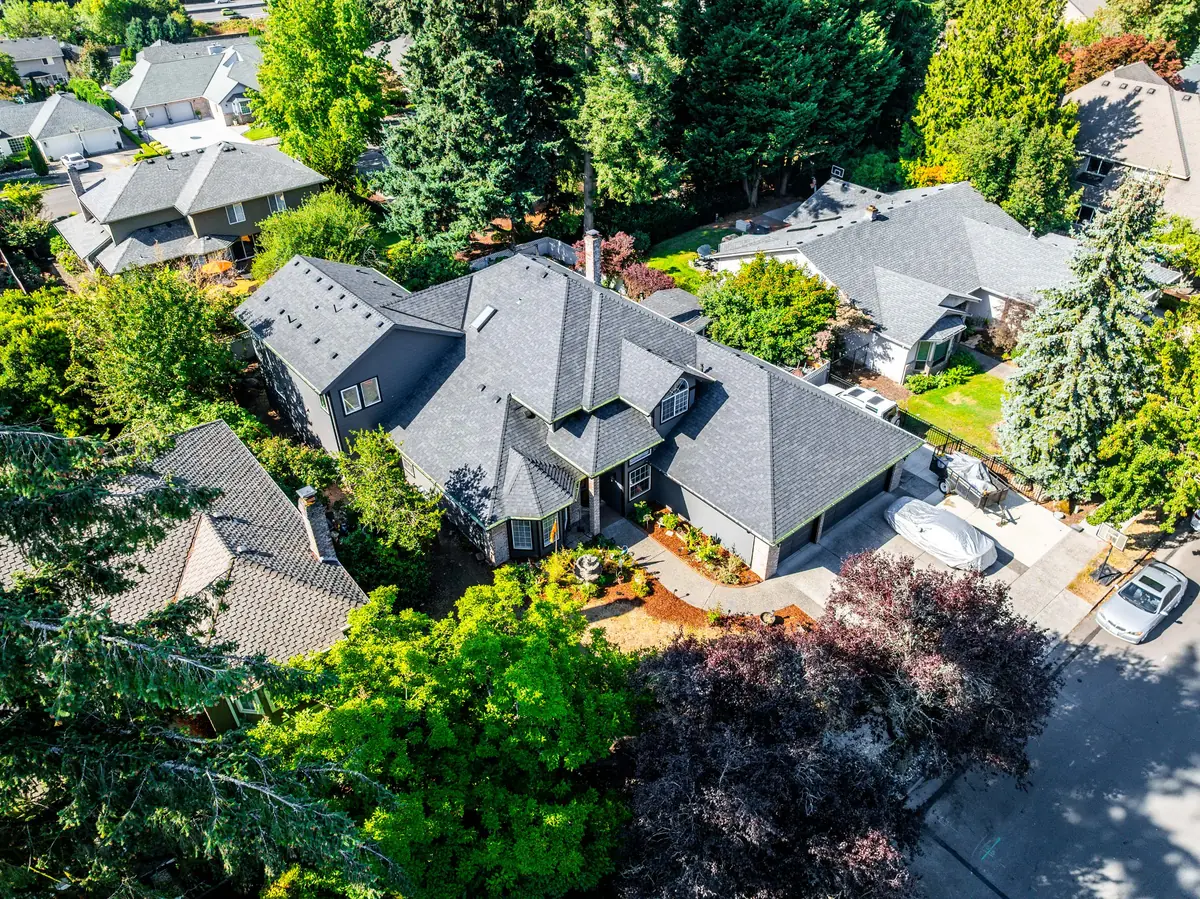 Angled aerial view of the new charcoal-gray roof, showing hips, valleys, and roof vents