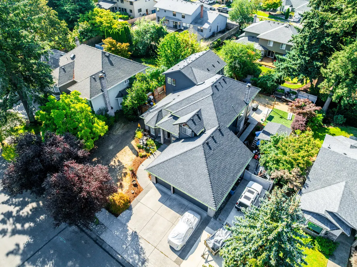 Aerial view of the front of the home and its new roof from above the driveway
