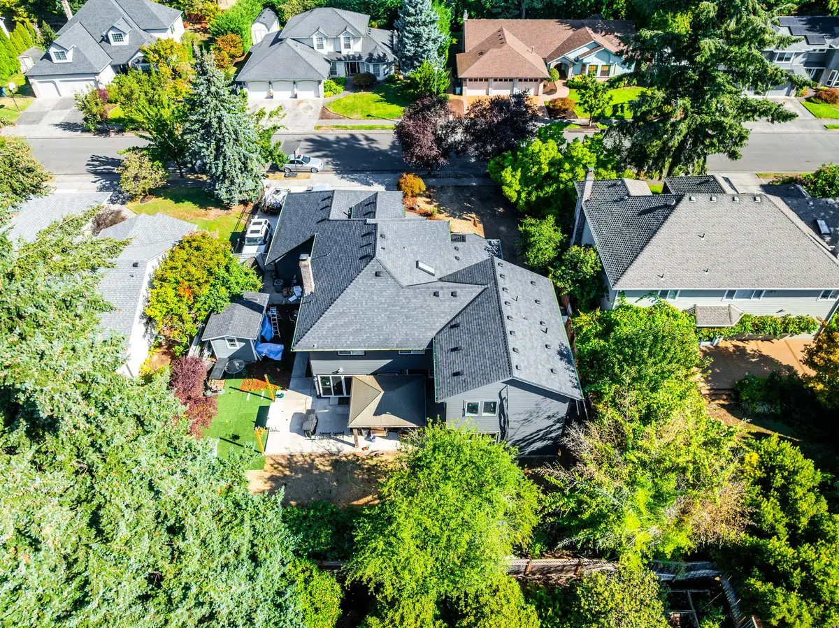 Rear aerial view of the new roof over the back patio, with the street and neighboring homes behind