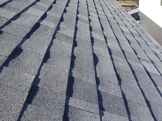 Close-up of new architectural asphalt shingles on a roof